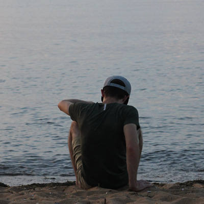 man-sitting-on-beach
